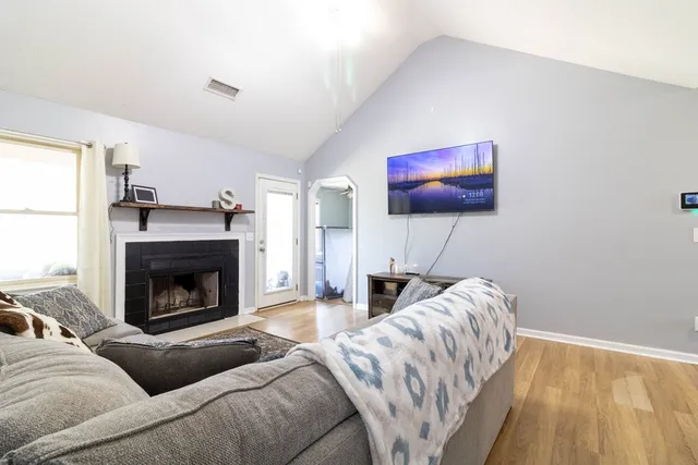 a living room with furniture and a fireplace