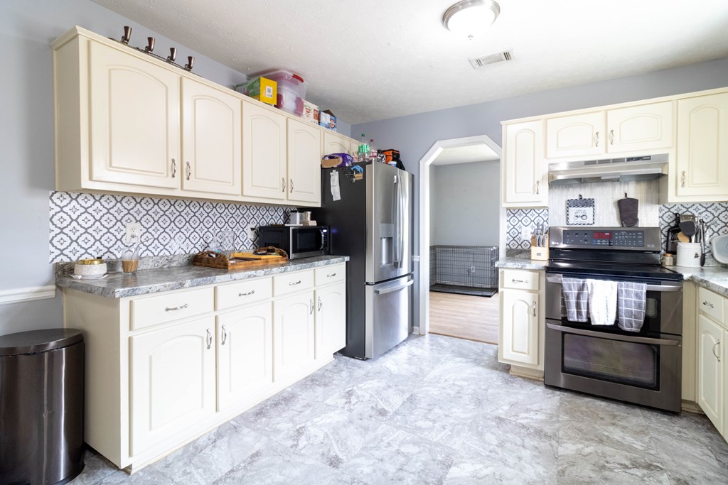 3381 Flintlock Drive Columbus, GA 31907 - Photo 14 of 39 a kitchen with refrigerator and cabinets