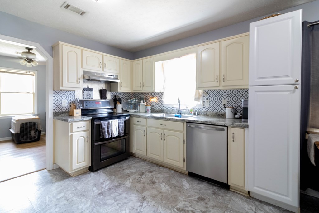 3381 Flintlock Drive Columbus, GA 31907 - Photo 15 of 39 a kitchen with white cabinets and white appliances