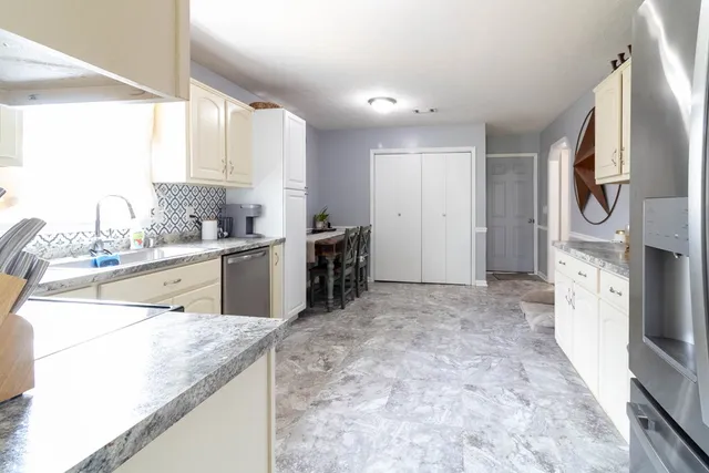 a kitchen with stainless steel appliances kitchen island granite countertop a sink and cabinets