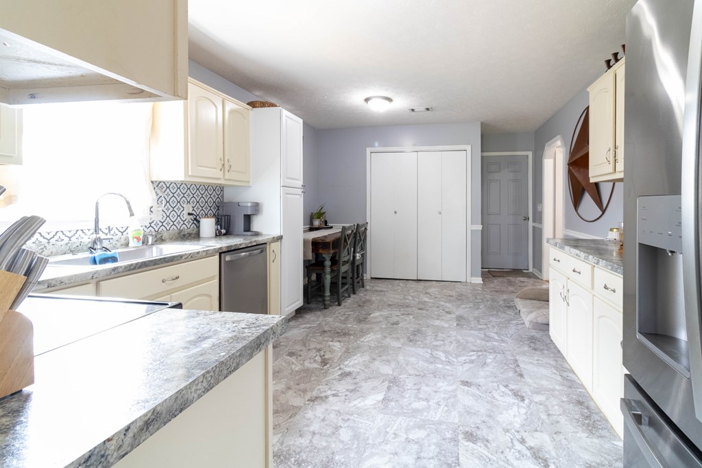 3381 Flintlock Drive Columbus, GA 31907 - Photo 16 of 39 a kitchen with stainless steel appliances kitchen island granite countertop a sink and cabinets