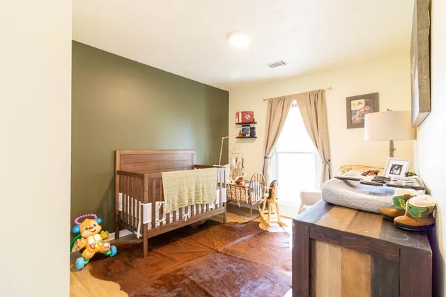 a bedroom with furniture and a window