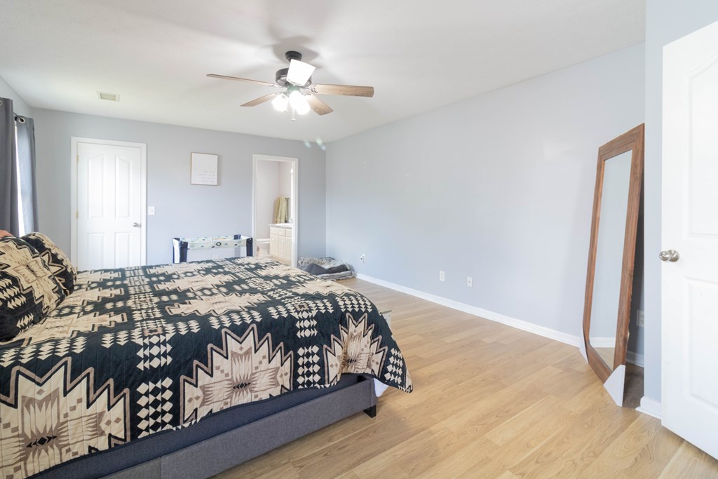 3381 Flintlock Drive Columbus, GA 31907 - Photo 25 of 39 a bedroom with a large bed and a chandelier