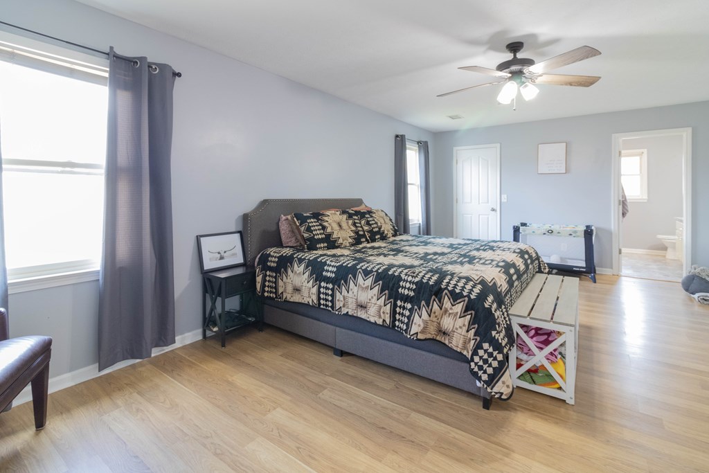 3381 Flintlock Drive Columbus, GA 31907 - Photo 26 of 39 a bedroom with a bed and a chandelier