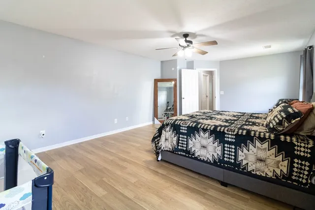 a bedroom with a bed and window