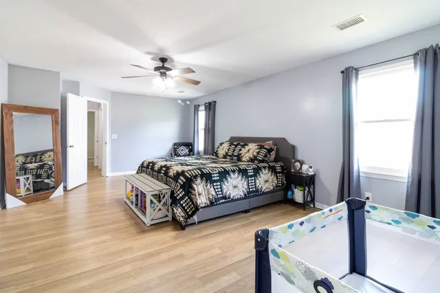 a bedroom with a bed and a chandelier