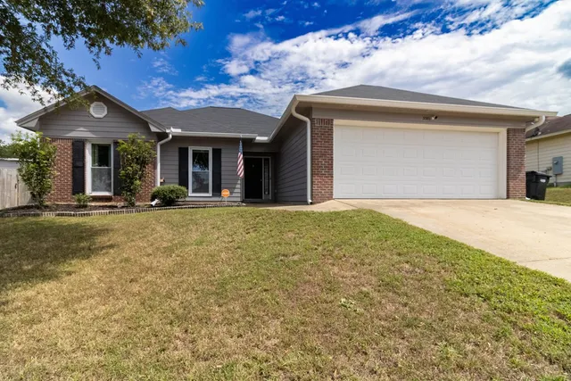 a front view of a house with a garden