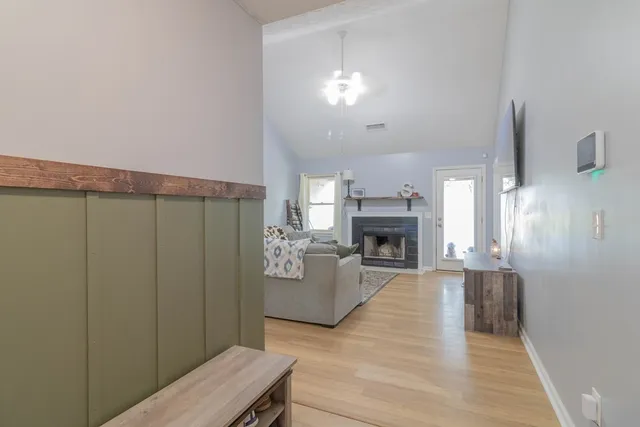 a view of a livingroom with a fireplace and window