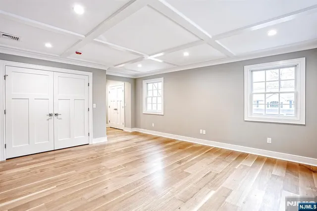 a spacious bedroom with a large bed and a window