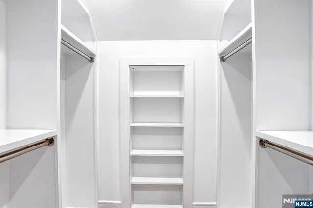 a view of a bedroom with wooden floor and closet