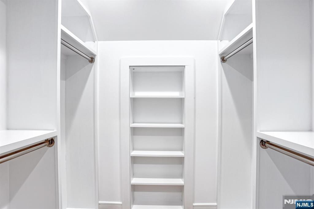 57 Mill Road Park Ridge, NJ 07656 - Photo 22 of 50 a view of walk in closet with empty racks