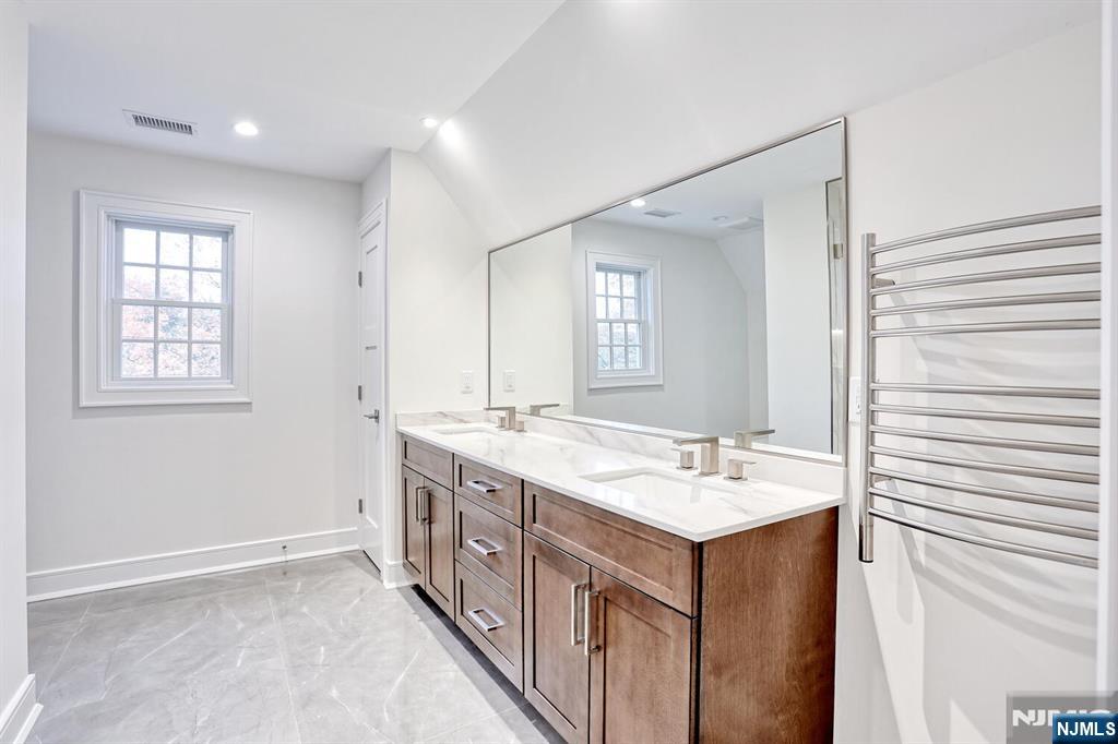 57 Mill Road Park Ridge, NJ 07656 - Photo 26 of 50 a bathroom with a granite countertop sink and a mirror