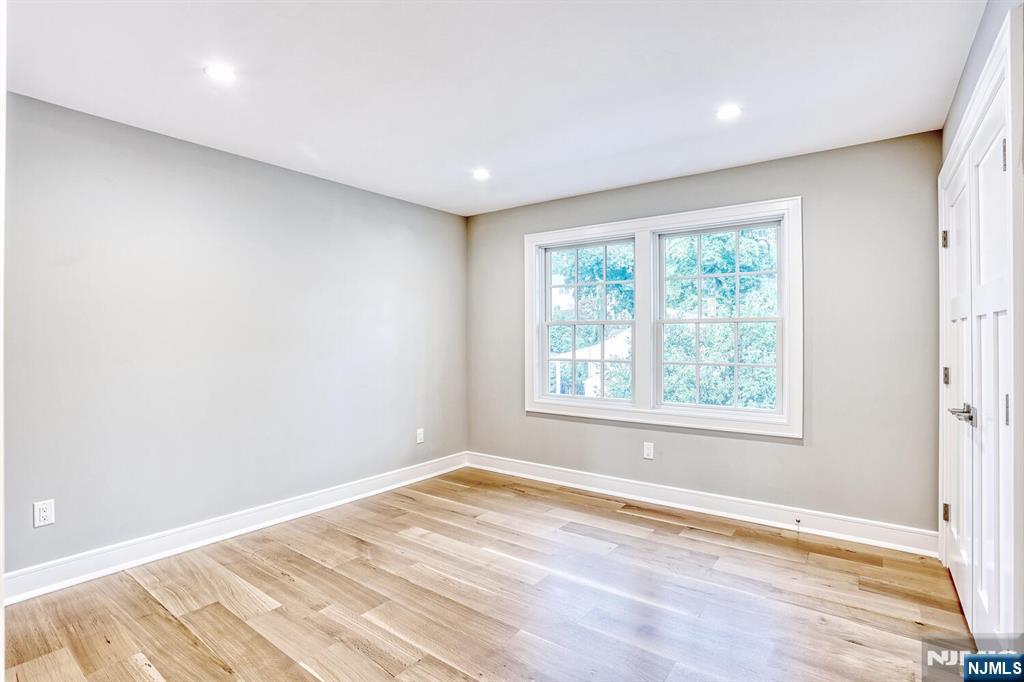 57 Mill Road Park Ridge, NJ 07656 - Photo 32 of 50 an empty room with wooden floor and windows