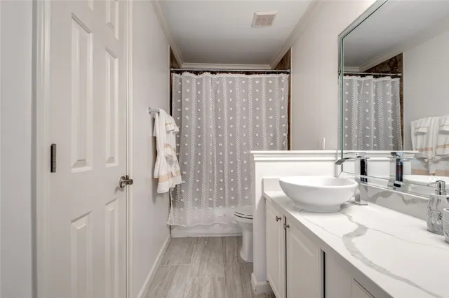 a bathroom with a sink toilet double vanity and tub