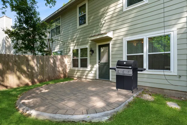 a view of a house with backyard porch and sitting area