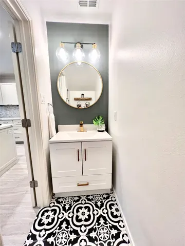 a room with a mirror and a sink