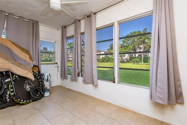 a view of a room with wooden floor and windows