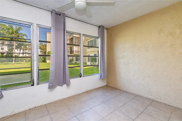 a view of an empty room with window front door