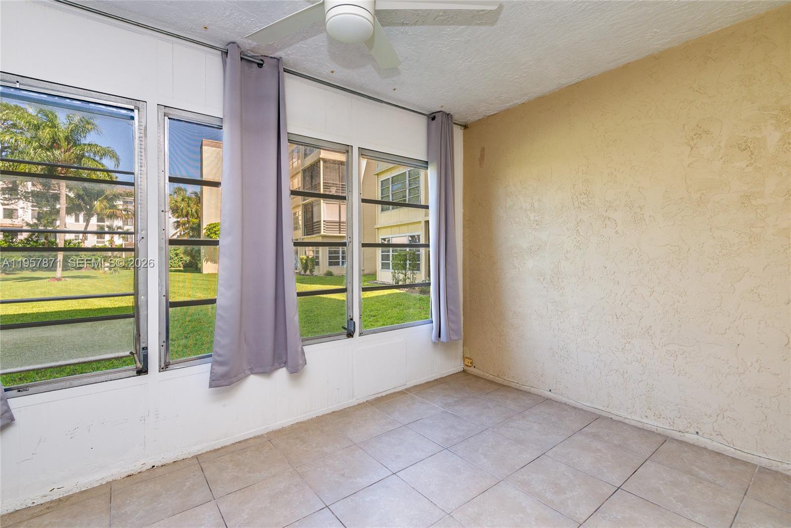 9355 Southwest 8th Street, Unit 105 Boca Raton, FL 33428 - Photo 16 of 37 a view of an empty room with window front door