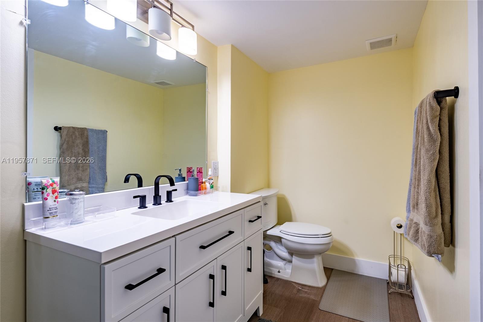 9355 Southwest 8th Street, Unit 105 Boca Raton, FL 33428 - Photo 22 of 37 a bathroom with a sink and a mirror