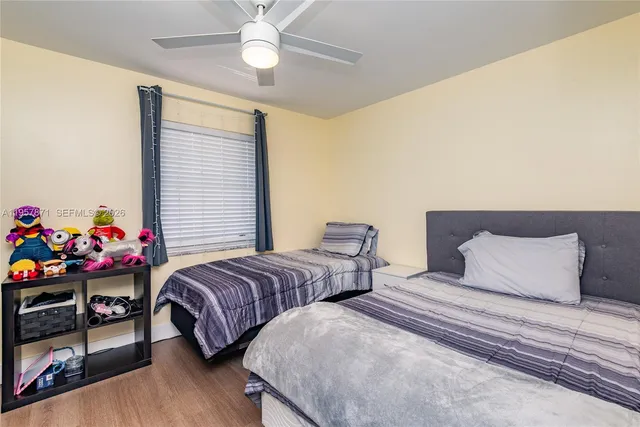 a bedroom with two beds and a chandelier