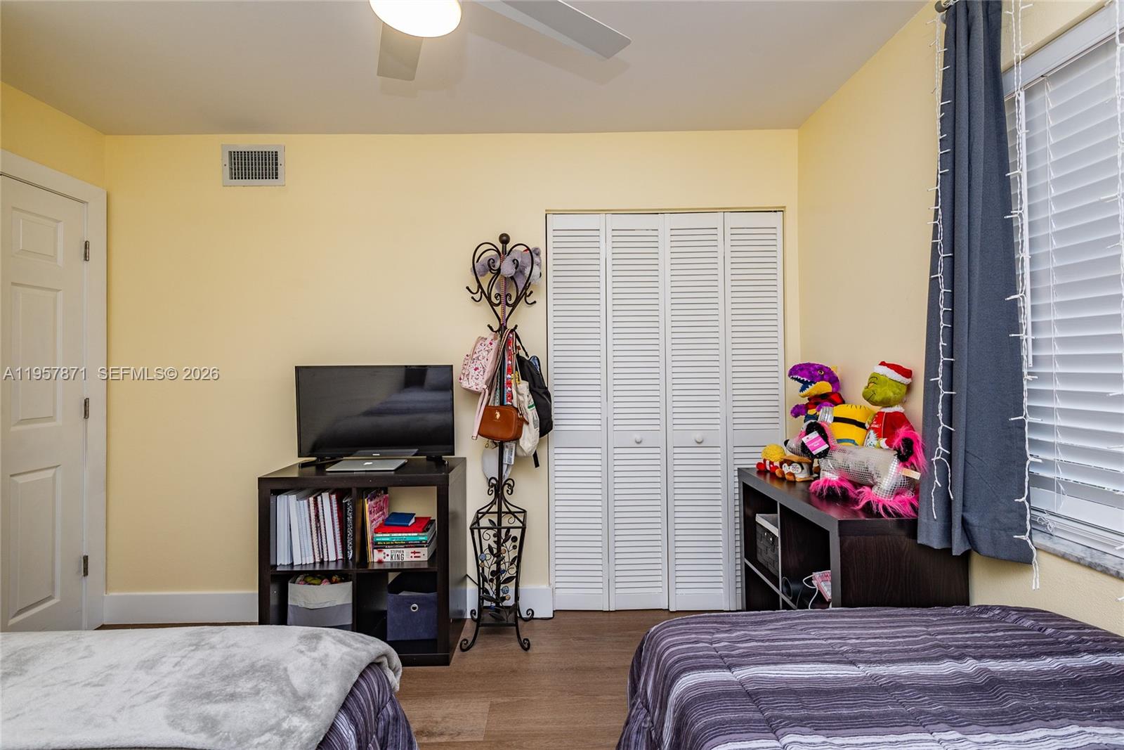 9355 Southwest 8th Street, Unit 105 Boca Raton, FL 33428 - Photo 26 of 37 a bedroom with a bed and a flat screen tv