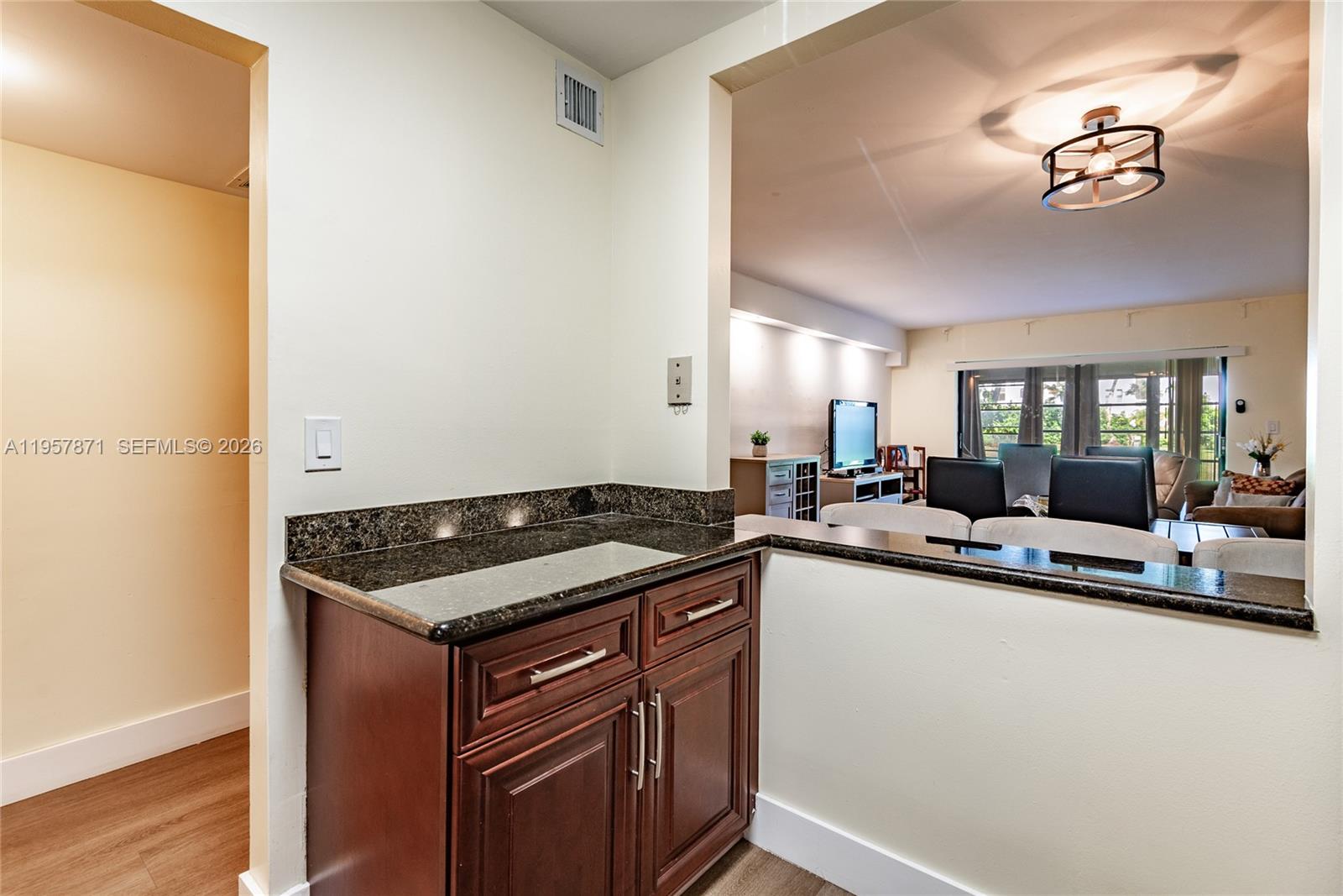 9355 Southwest 8th Street, Unit 105 Boca Raton, FL 33428 - Photo 3 of 37 a kitchen with a sink and cabinets