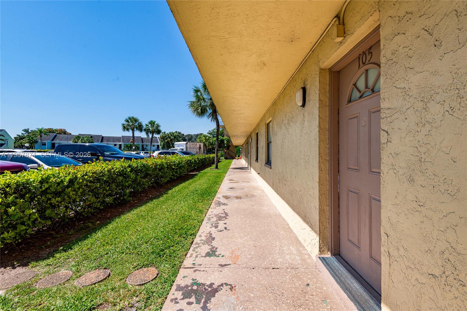 9355 Southwest 8th Street, Unit 105 Boca Raton, FL 33428 - Photo 35 of 37 a view of flowing water with large building in front of it