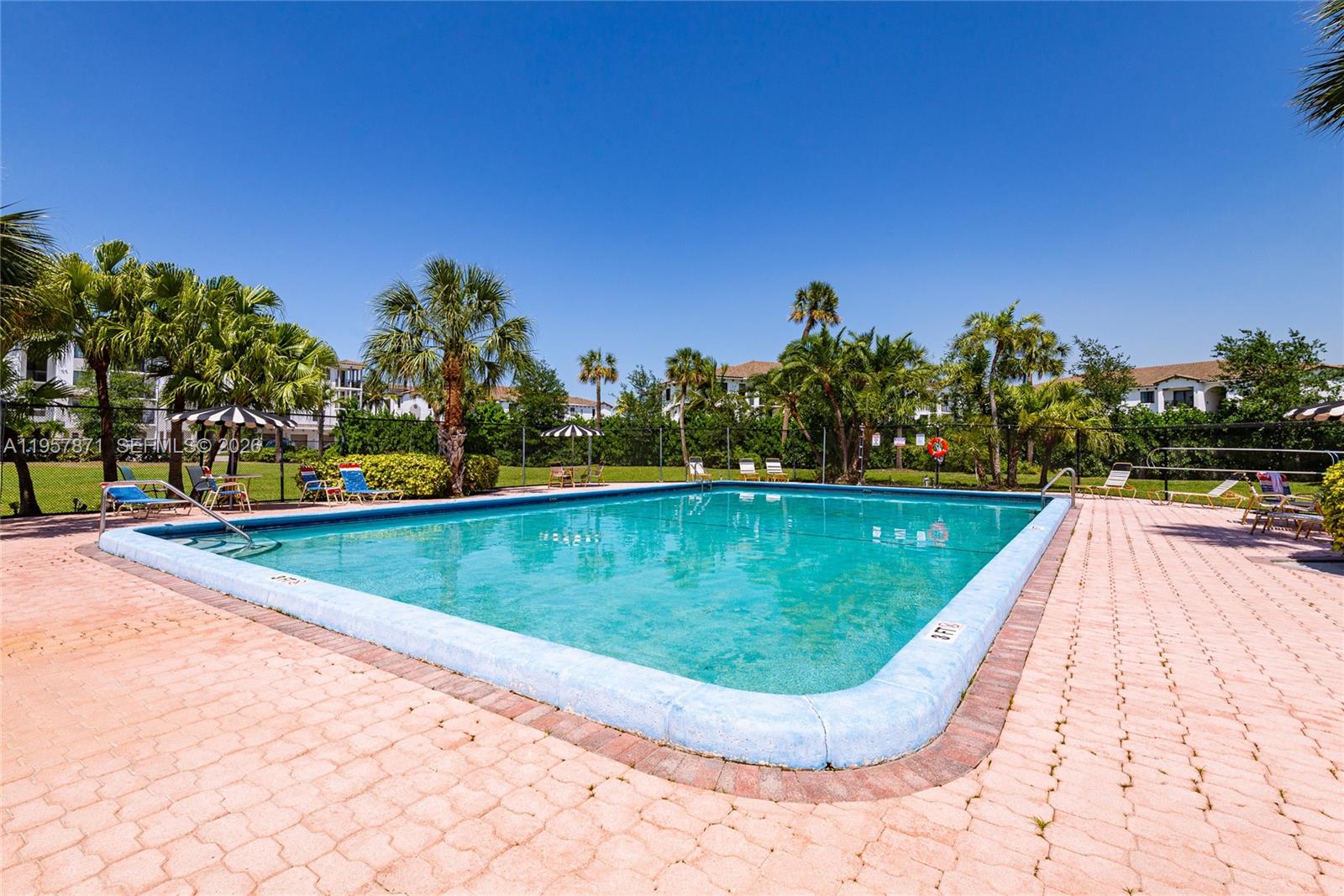 9355 Southwest 8th Street, Unit 105 Boca Raton, FL 33428 - Photo 36 of 37 a view of a swimming pool with a yard