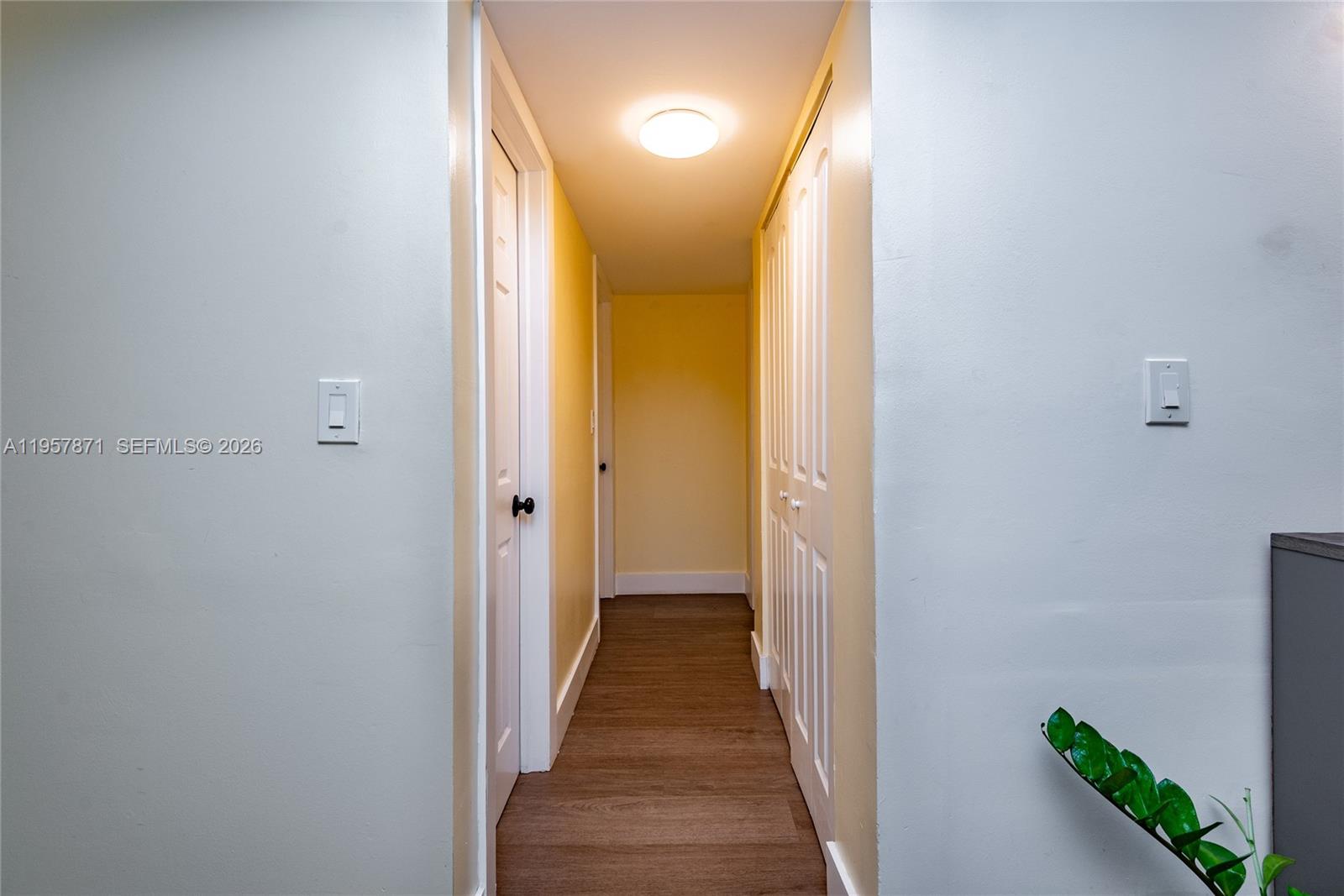 9355 Southwest 8th Street, Unit 105 Boca Raton, FL 33428 - Photo 8 of 37 a view of a hallway with wooden floor