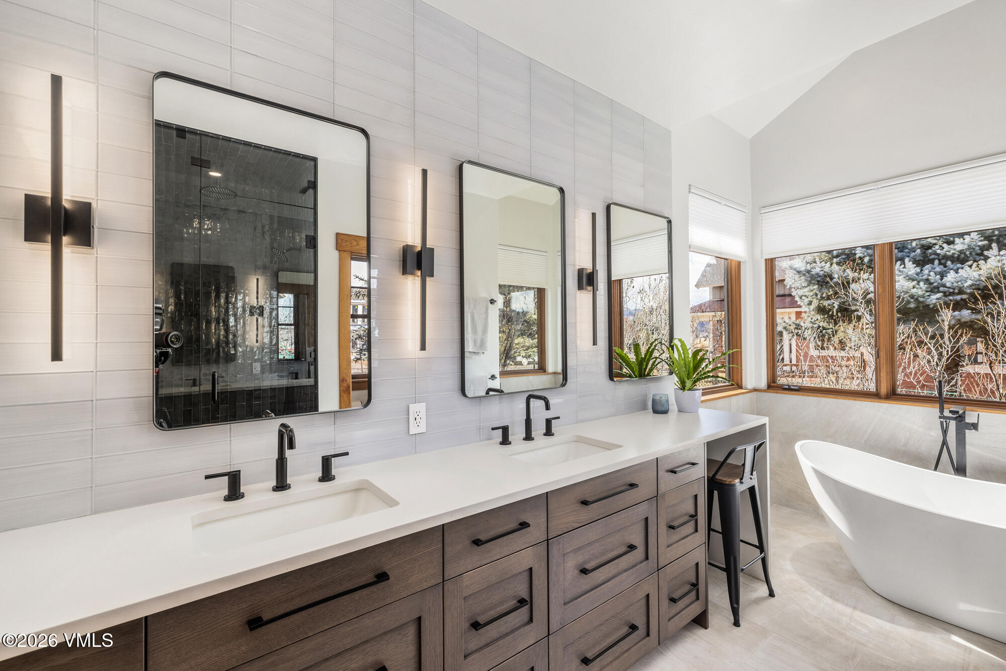 2044 Eagle Ranch Road Eagle, CO 81631 - Photo 14 of 39 a bathroom with double vanity sinks a large mirror and a bathtub