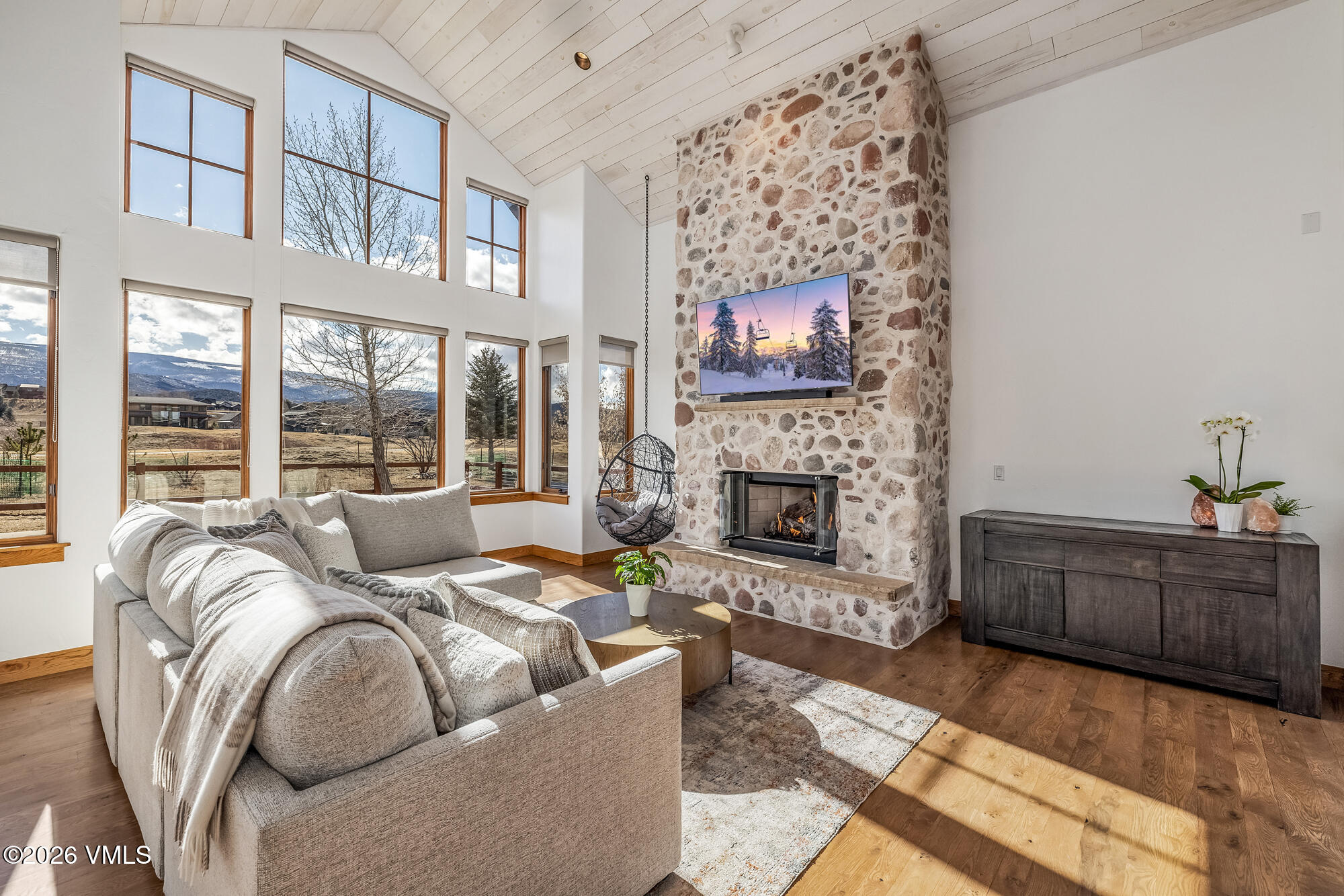2044 Eagle Ranch Road Eagle, CO 81631 - Photo 2 of 39 a living room with furniture large window and a fireplace