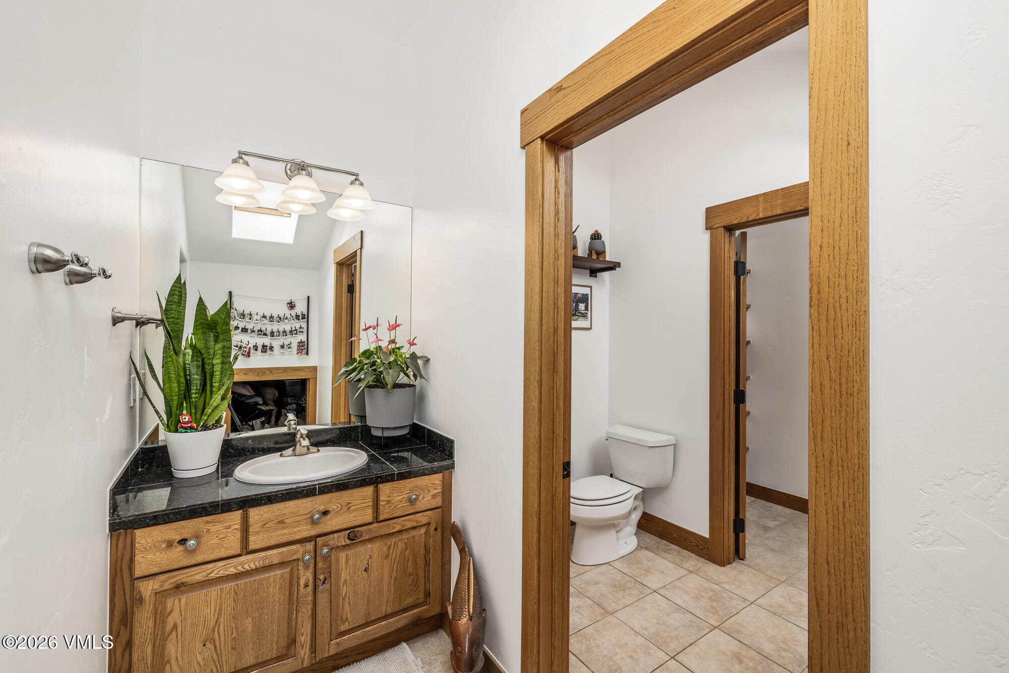 2044 Eagle Ranch Road Eagle, CO 81631 - Photo 22 of 39 a bathroom with a granite countertop sink a toilet and a mirror
