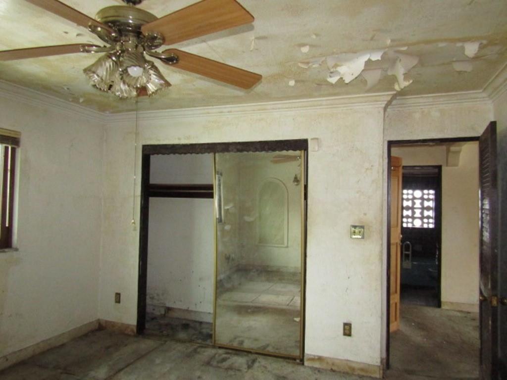 219 Camp Avenue Braddock, PA 15104 - Photo 26 of 27 an empty room that has a chandelier fan and kitchen view