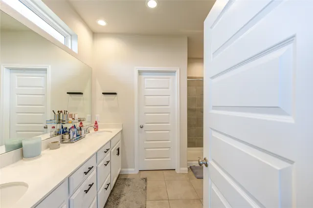 a bathroom with a double vanity sink a and a mirror