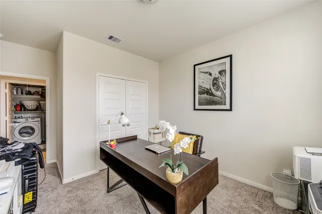 a living room with furniture a rug and a wall painting