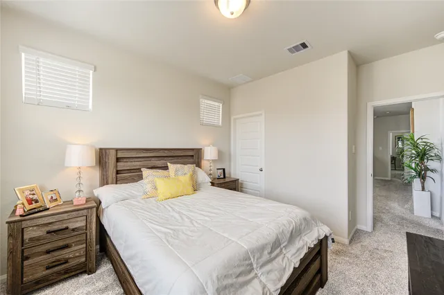 a bedroom with a bed and a potted plant