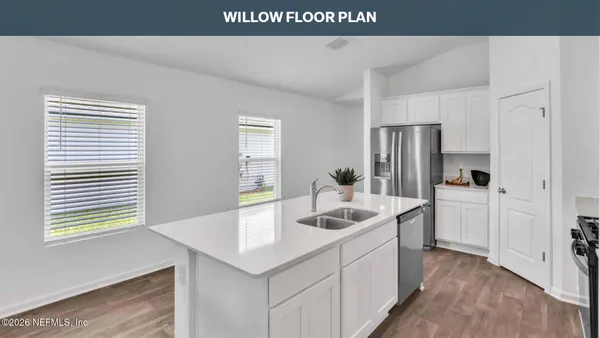 a kitchen that has a sink and a refrigerator