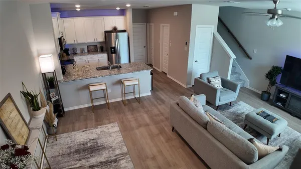 a kitchen with stainless steel appliances kitchen island granite countertop a sink stove and refrigerator