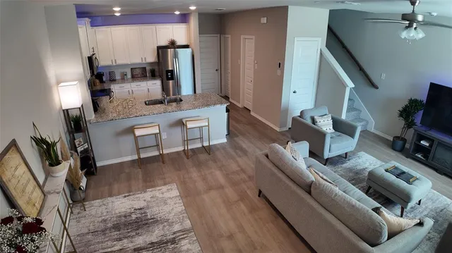 a kitchen with stainless steel appliances kitchen island granite countertop a sink stove and refrigerator