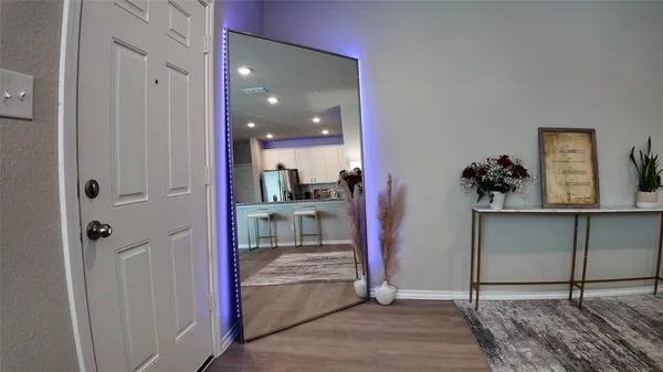 a view of a hallway and a livingroom with furniture