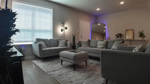 a living room with furniture and a large window