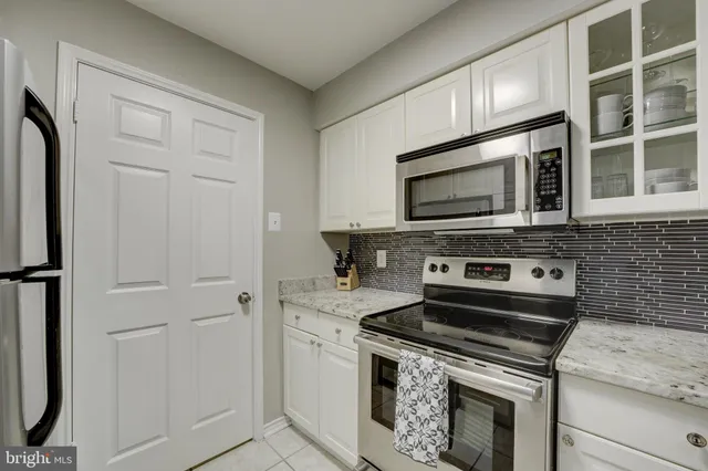 a kitchen with stainless steel appliances granite countertop a stove and a microwave