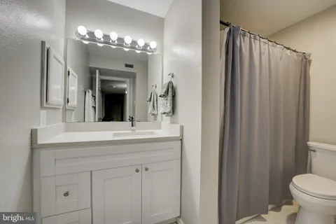 a bedroom with a bed and a desk