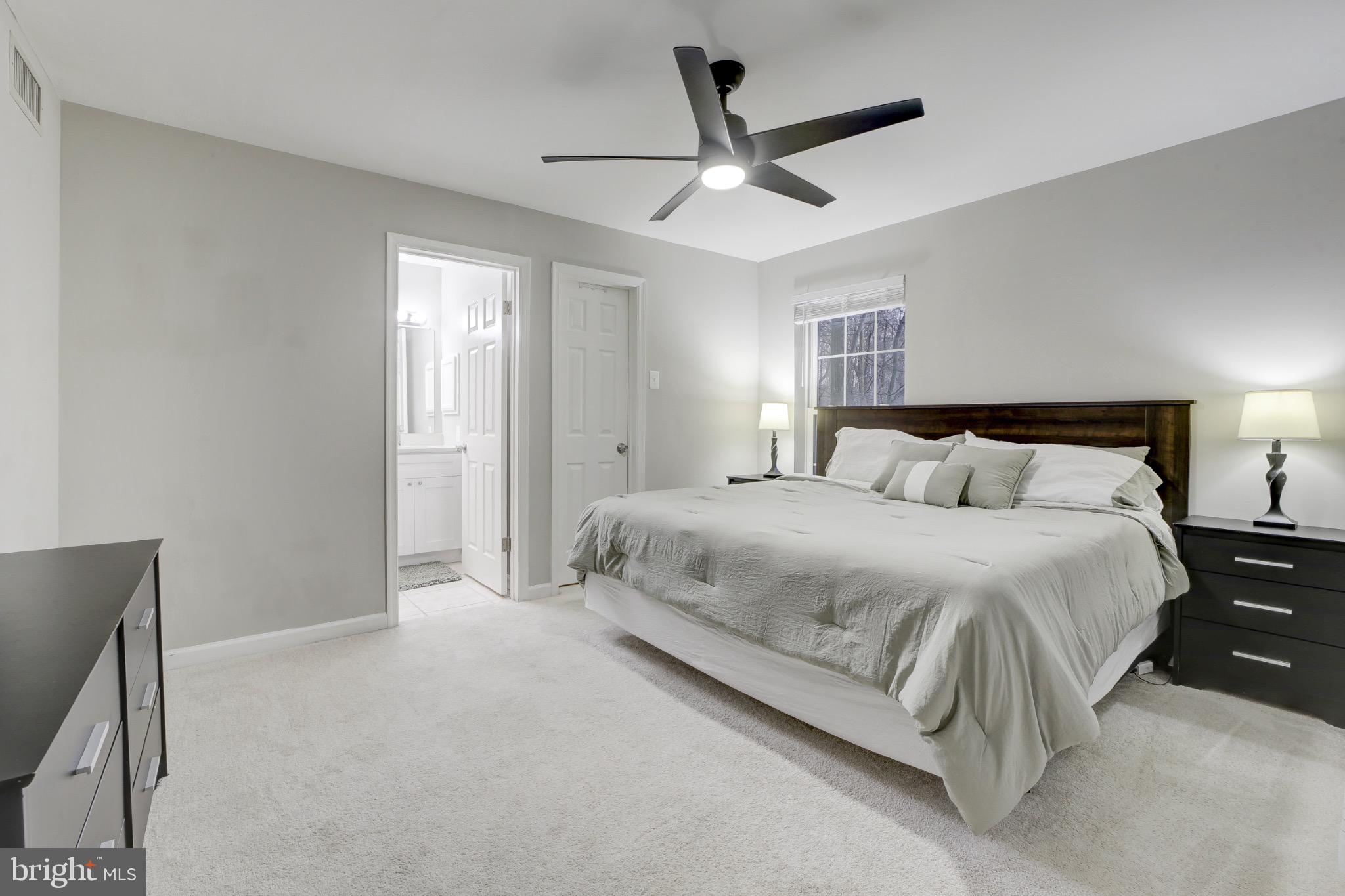 1501 Lincoln Way, Unit 101 McLean, VA 22102 - Photo 15 of 23 a bedroom with a large bed and a ceiling fan