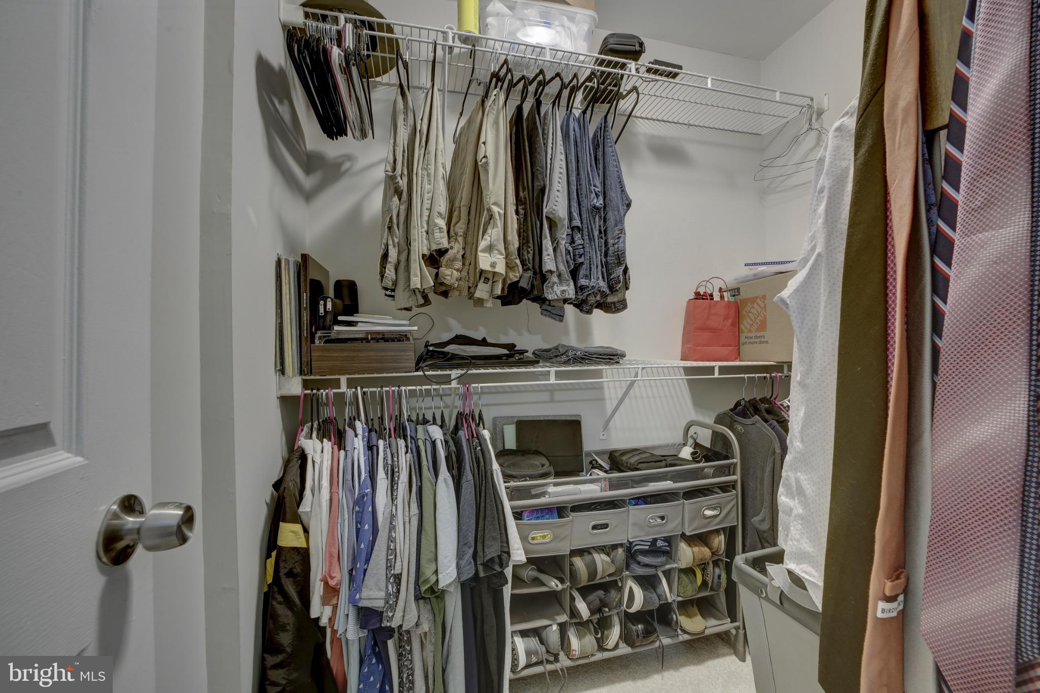 1501 Lincoln Way, Unit 101 McLean, VA 22102 - Photo 16 of 23 a view of walk in closet with clothes and shoes
