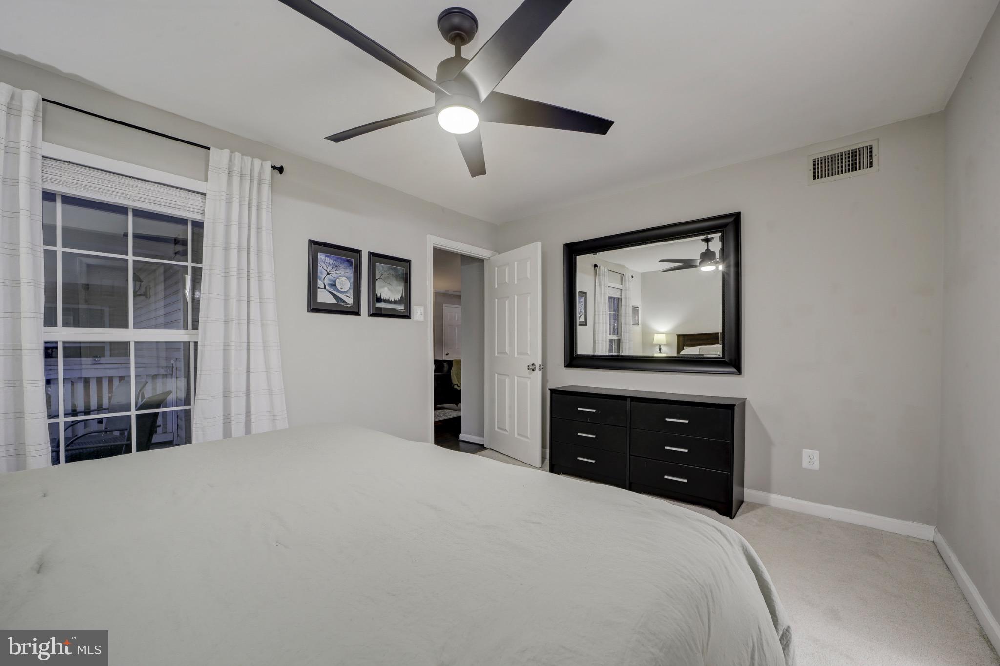 1501 Lincoln Way, Unit 101 McLean, VA 22102 - Photo 17 of 23 a bedroom with a bed and a flat tv screen on dresser