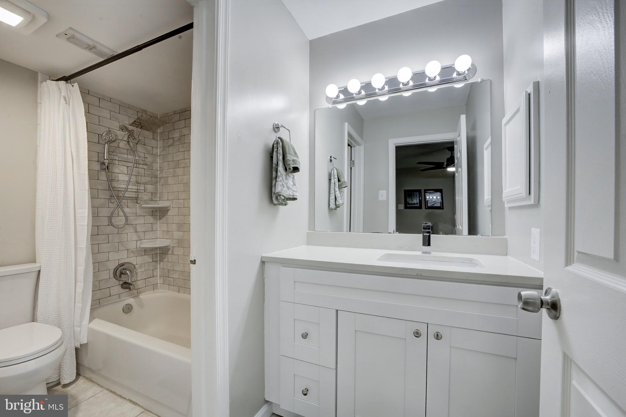 1501 Lincoln Way, Unit 101 McLean, VA 22102 - Photo 18 of 23 a bathroom with a sink a toilet and shower