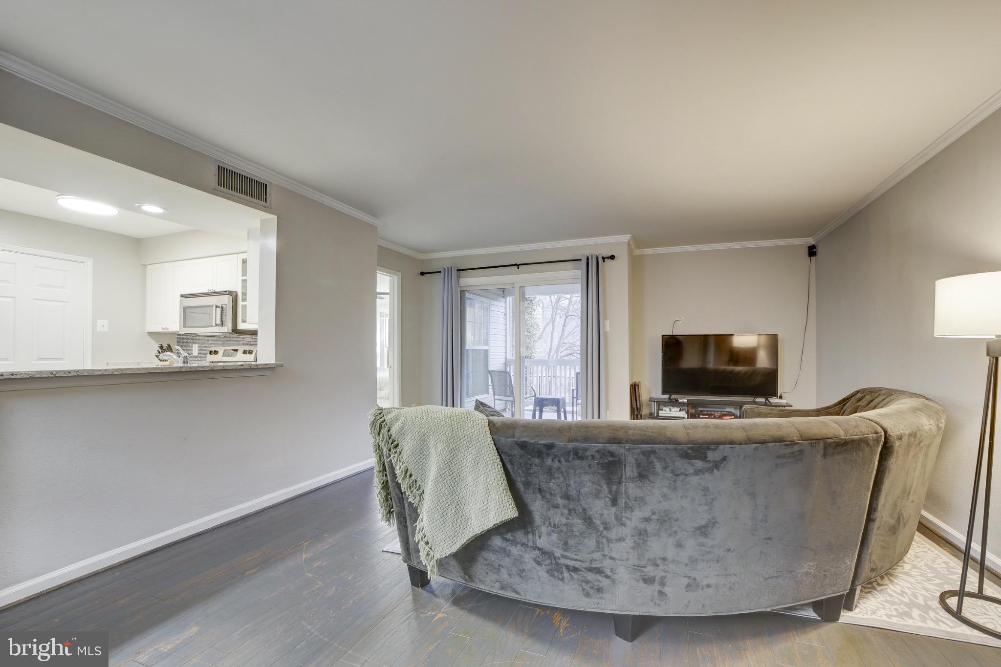 1501 Lincoln Way, Unit 101 McLean, VA 22102 - Photo 5 of 23 a living room with fireplace furniture and a flat screen tv