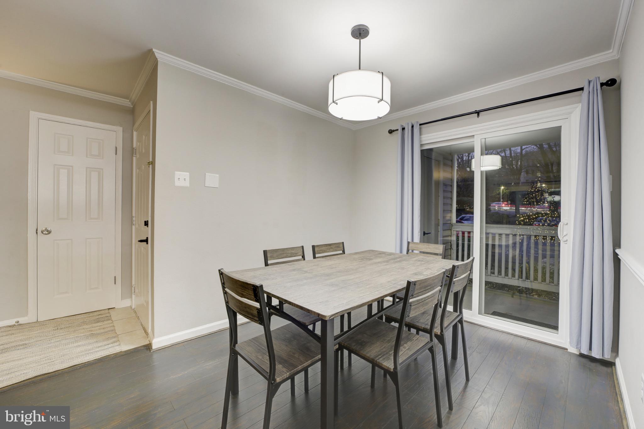 1501 Lincoln Way, Unit 101 McLean, VA 22102 - Photo 7 of 23 a view of a dining room with furniture wooden floor and chandelier